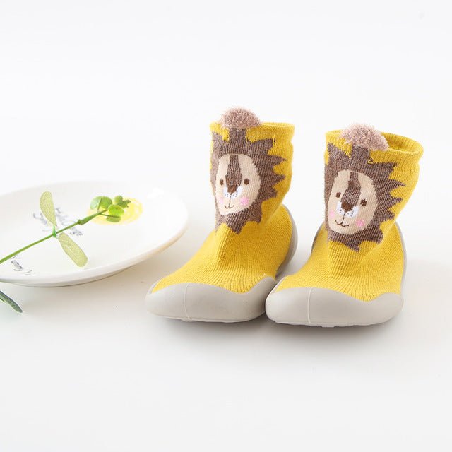 Yellow baby socks with a lion design