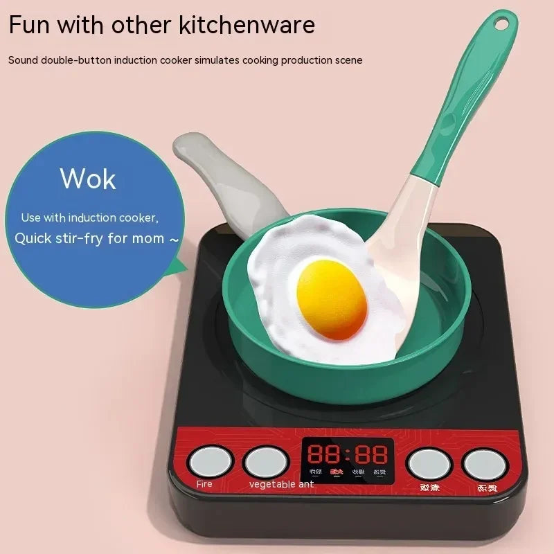 Induction cooker with a green wok and fried egg, featuring a toy spatula.
