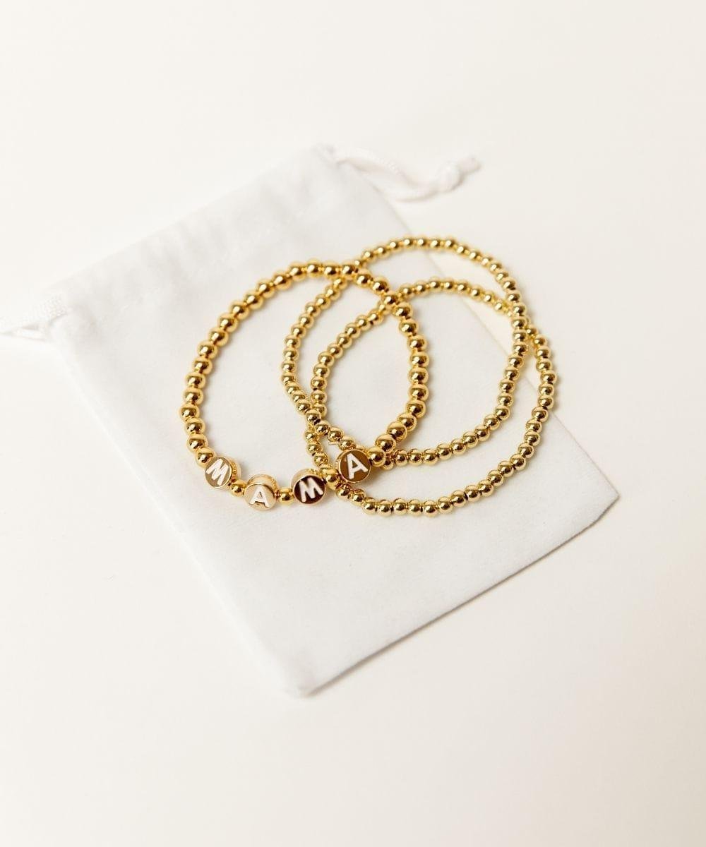 Gold chain necklaces on a white surface