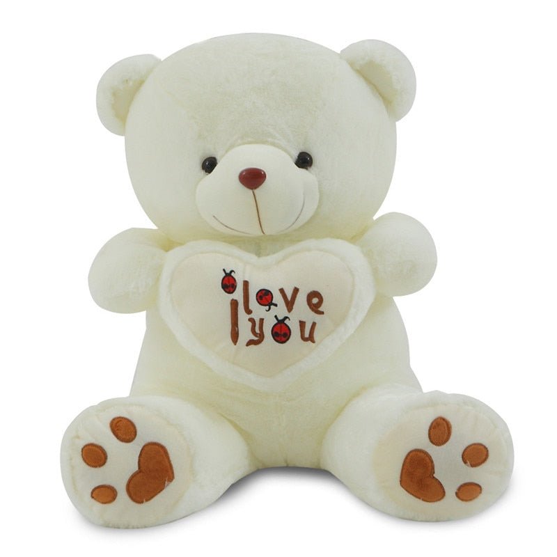 White teddy bear with a heart that says 'I love you'.