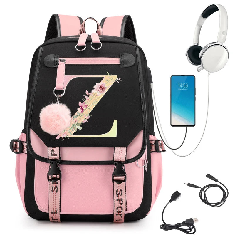 Pink and black backpack with floral letter 'Z' design, smartphone, headphones, and USB cable
