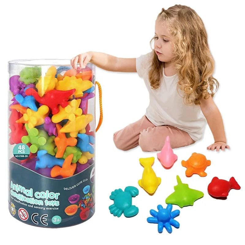 Child playing with colorful animal-shaped toys next to a large container of toys.