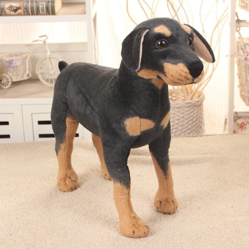 Plush toy resembling a Doberman Pinscher on a carpeted floor.