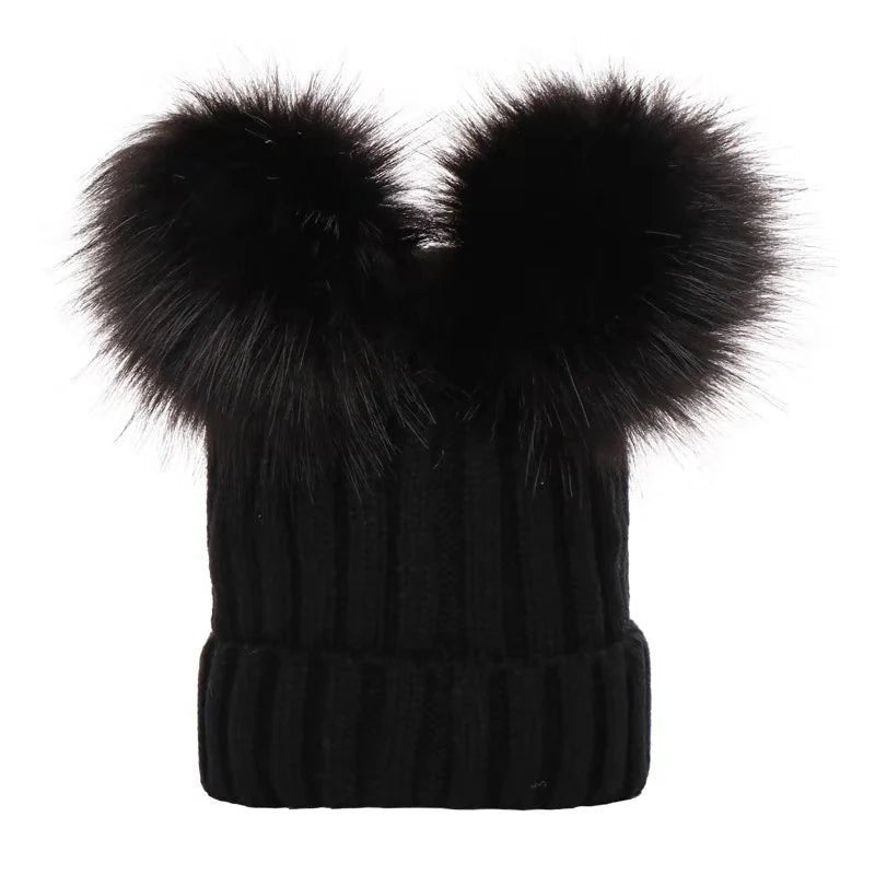 Black knit beanie with large black fur pom-poms