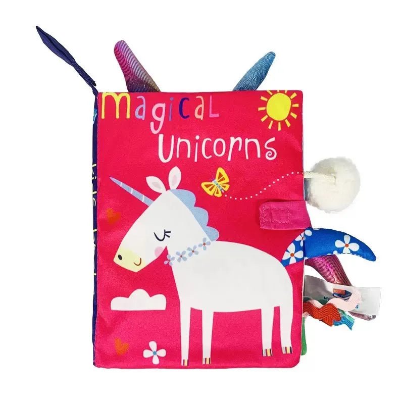 Children's soft book with unicorn illustration and 'magical unicorns' text on a pink cover.