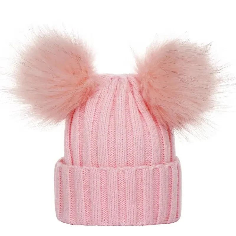 Pink knit beanie with two large pom-poms