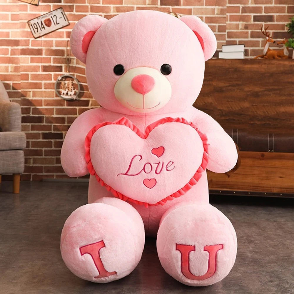 Pink teddy bear with 'I Love U' message in a living room setting