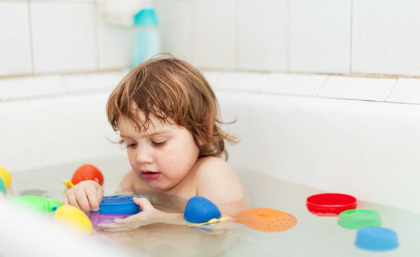 Kid playing with Bath Toys