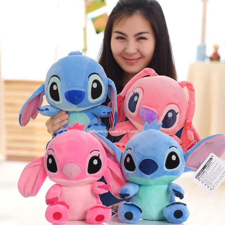Person holding four colorful plush toys resembling cartoon characters.