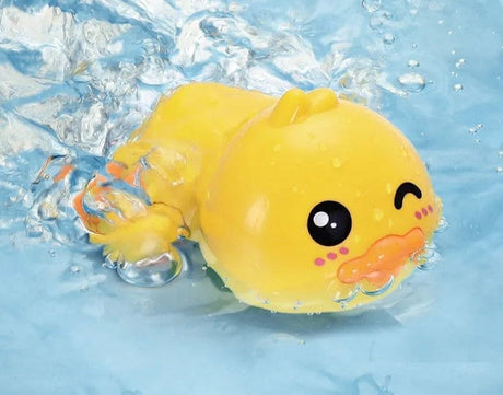 Yellow rubber duck with a happy face in water