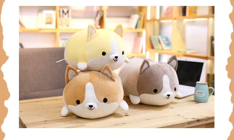 Three plush dog toys on a desk with a blurred background