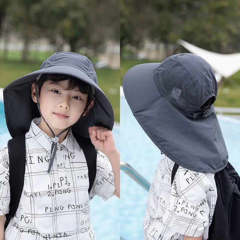 Child wearing a gray sun hat with neck flap outdoors