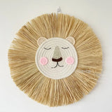 Decorative wall hanging with lion face design on a white background
