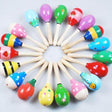 Colorful wooden maracas arranged in a circular pattern on a light gray background