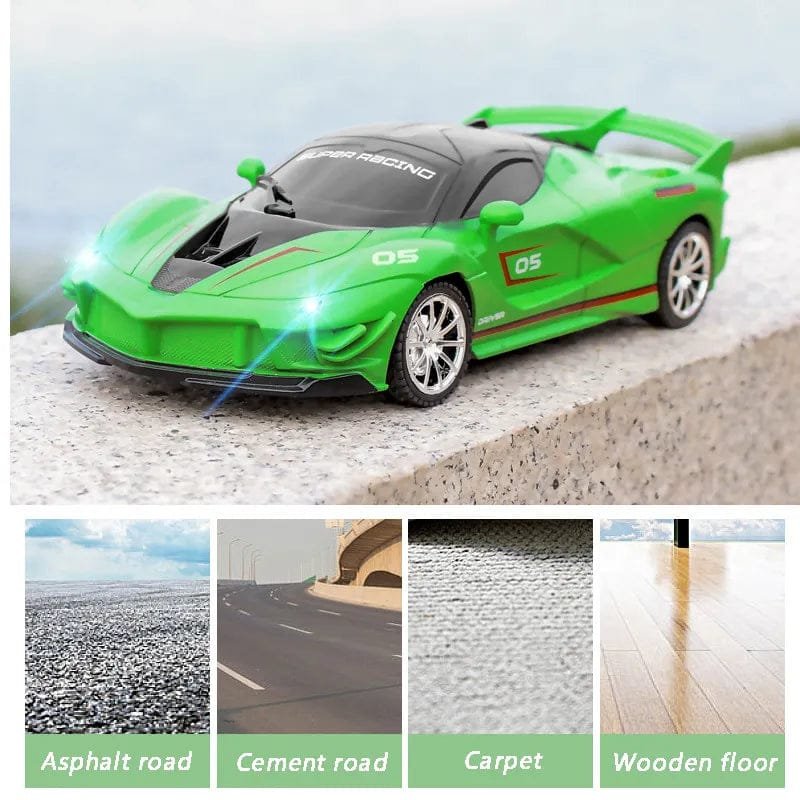 Green toy car on a concrete surface with road types below