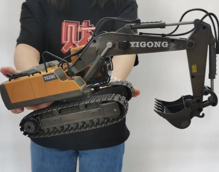 1:20 RC excavator construction toy held in hand, a 2.4G remote control truck for sandpit digging play.