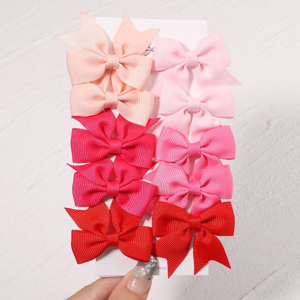 Set of pink and red hair bows on a white background