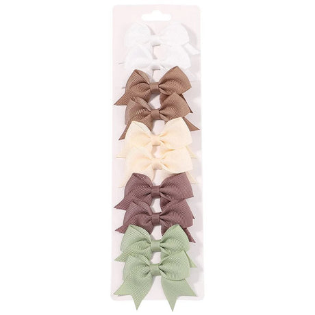 Set of five hair bows in different colors on a white background