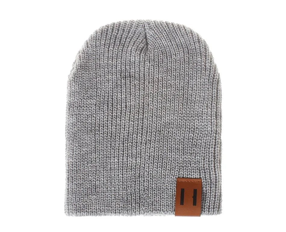 Gray knit beanie with a brown leather patch on a white background