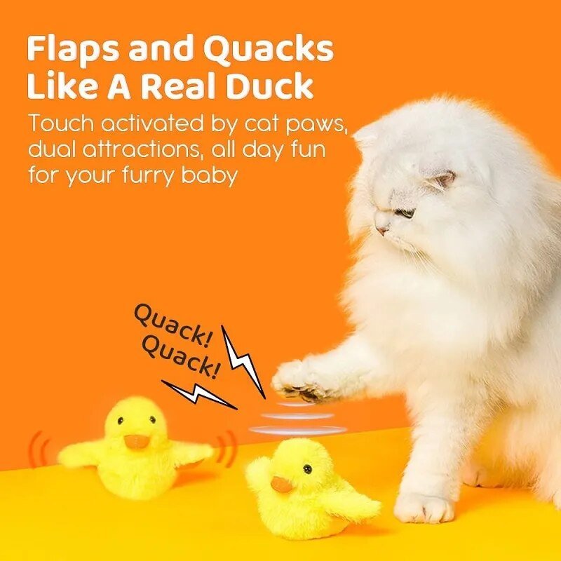 White cat playing with yellow duck-shaped toy on an orange background