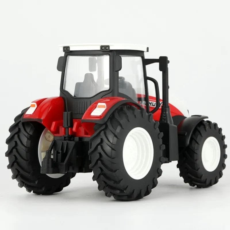Model tractor with large wheels on a white background