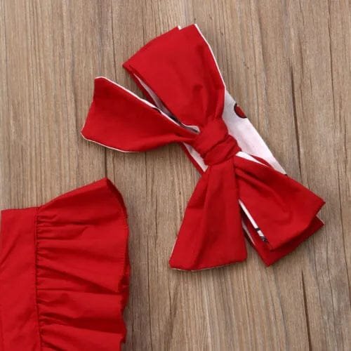 Red headband with a large bow on a wooden surface