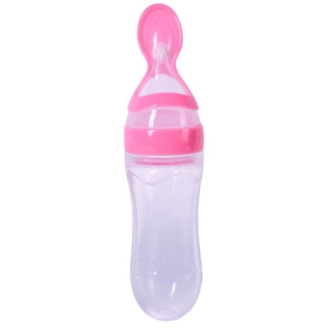 Pink and clear baby bottle with a spoon attachment on a white background (option 2)