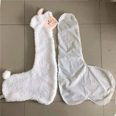 White plush llama toy and transparent plastic cover on a tiled floor