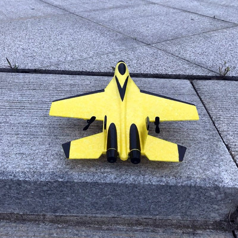 Yellow toy airplane on a concrete surface