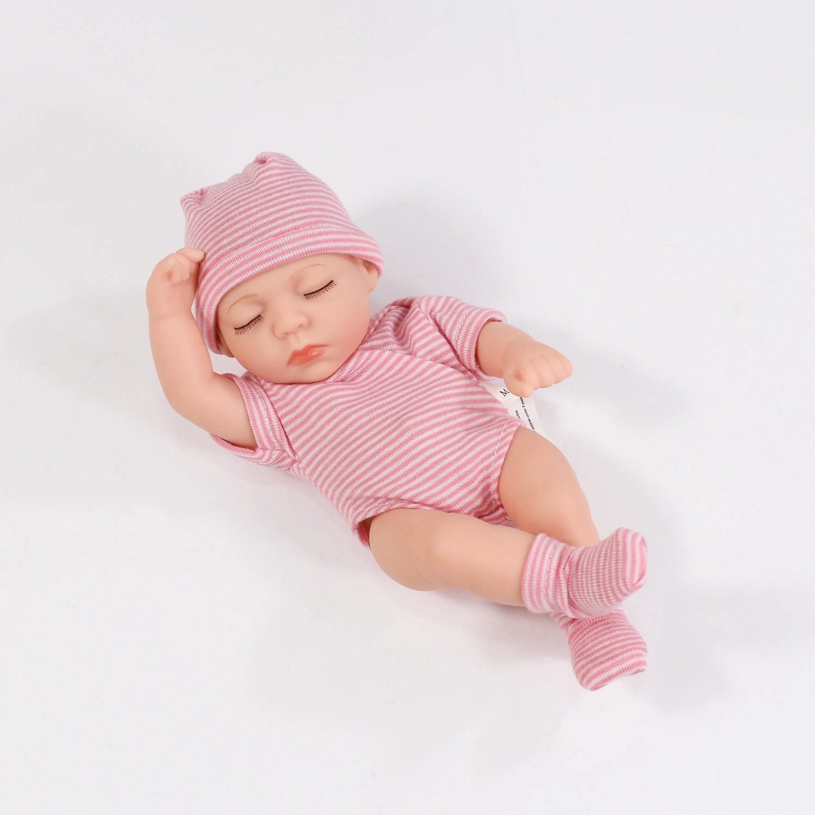 Newborn baby in a pink striped outfit and hat 