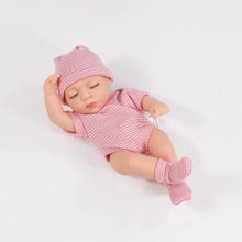 Newborn baby in a pink striped outfit and hat 