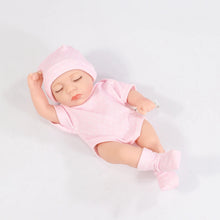 Baby doll in a pink outfit and a hat 