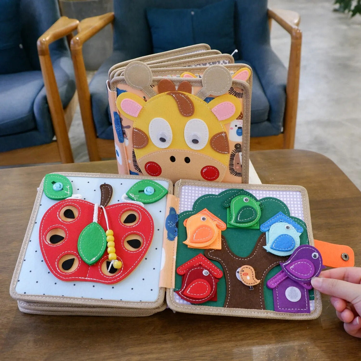 Colorful children's activity books with animal and nature-themed designs on a wooden table.