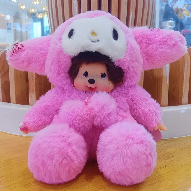 Pink plush toy with a small doll inside on a wooden surface