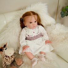 Artist-made Mattia reborn doll in a seated pose with rooted hair, ideal for collectors and reborn keepsakes.