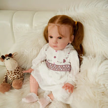 Lifelike Mattia reborn doll in an embroidered white dress with silicone skin for photo props and display.