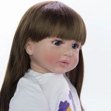 Close-up of the realistic reborn princess toddler doll with long hair and soft cloth body for lifelike play.