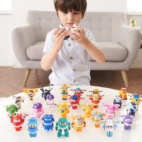 Child playing with colorful toy figures on a table in a living room.