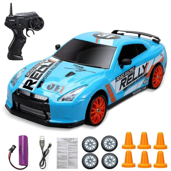 Blue 2.4G 4WD RC Drift Car GTR model with remote, spare wheels and track cones for kids drift racing practice.