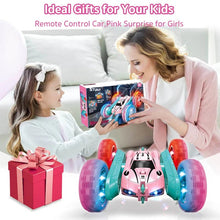 Pink off-road RC stunt car with big wheels being enjoyed by a parent and child as a birthday gift toy.