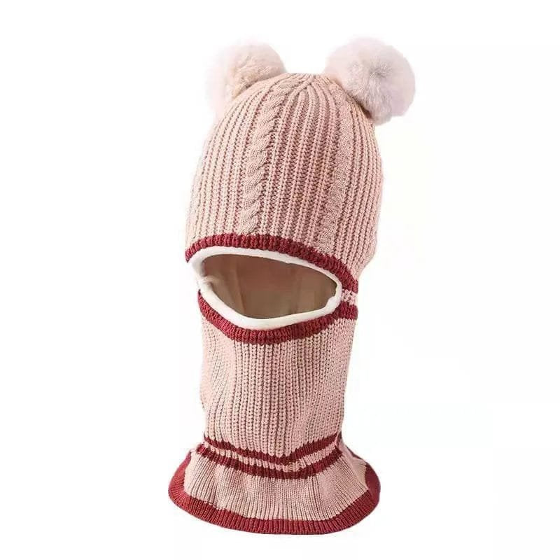 Knitted balaclava with pom-poms on a white background