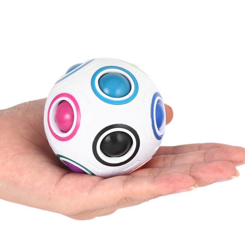 Colorful fidget spinner held in a hand on a white background