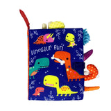 Children's soft book with colorful dinosaur illustrations on a blue background
