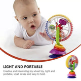 Baby playing with a colorful sky wheel toy on a white background
