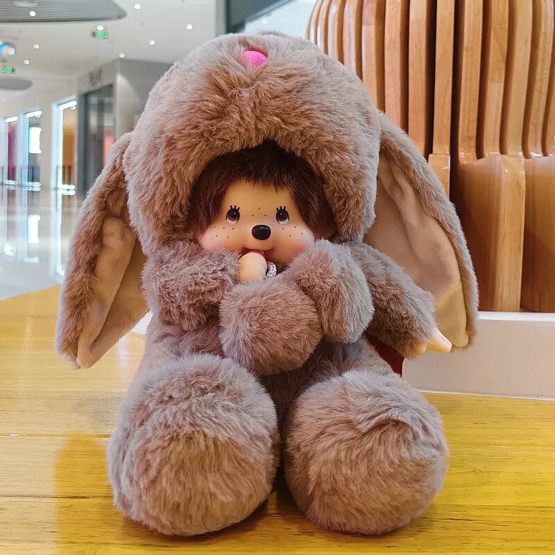 Plush toy resembling a character with bunny ears on a wooden floor.