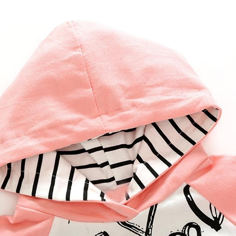 Close view of the pink hood and patterned lining, showing the soft cotton fabric used for comfy all day wear.