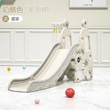 Children's slide with basketball hoop and balls on a light wooden floor.