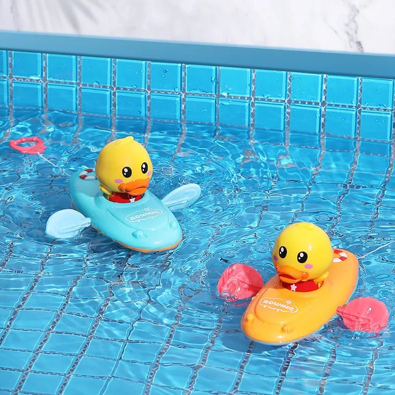 Two rubber duck toys in a pool with tiled walls.