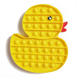 Yellow duck-shaped pop-it fidget toy on a white background