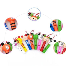Close up of colorful wooden animal whistle toys for kids party favors and baby shower giveaways.